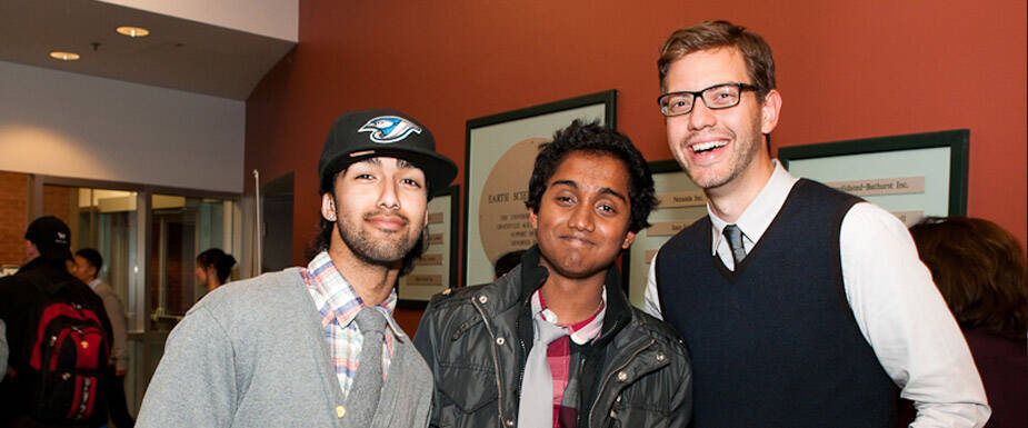 3 young men gathered and smile for a pic