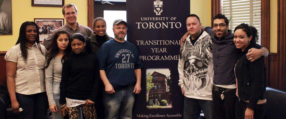 University students having picture with a banner for Transitional Year Programme
